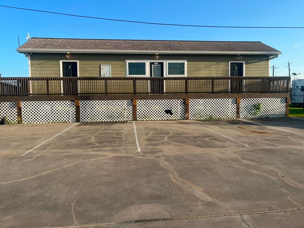 Laundry and bathhouse building exterior with covered deck and ADA ramp