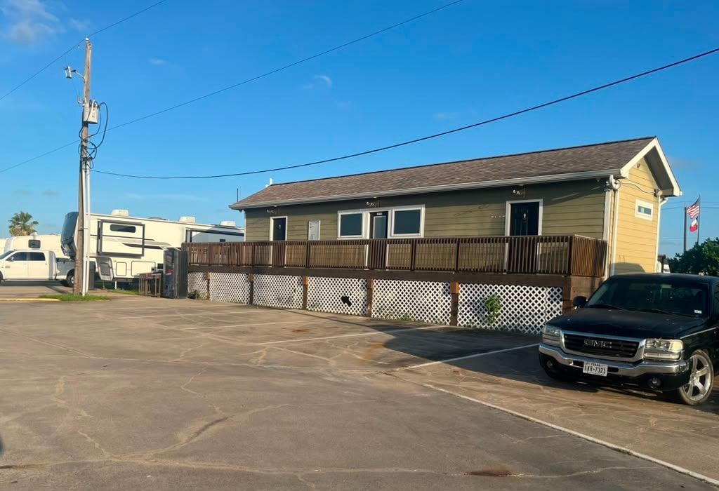 Angled view of the laundry and bathhouse building with landscaping and paved walkway