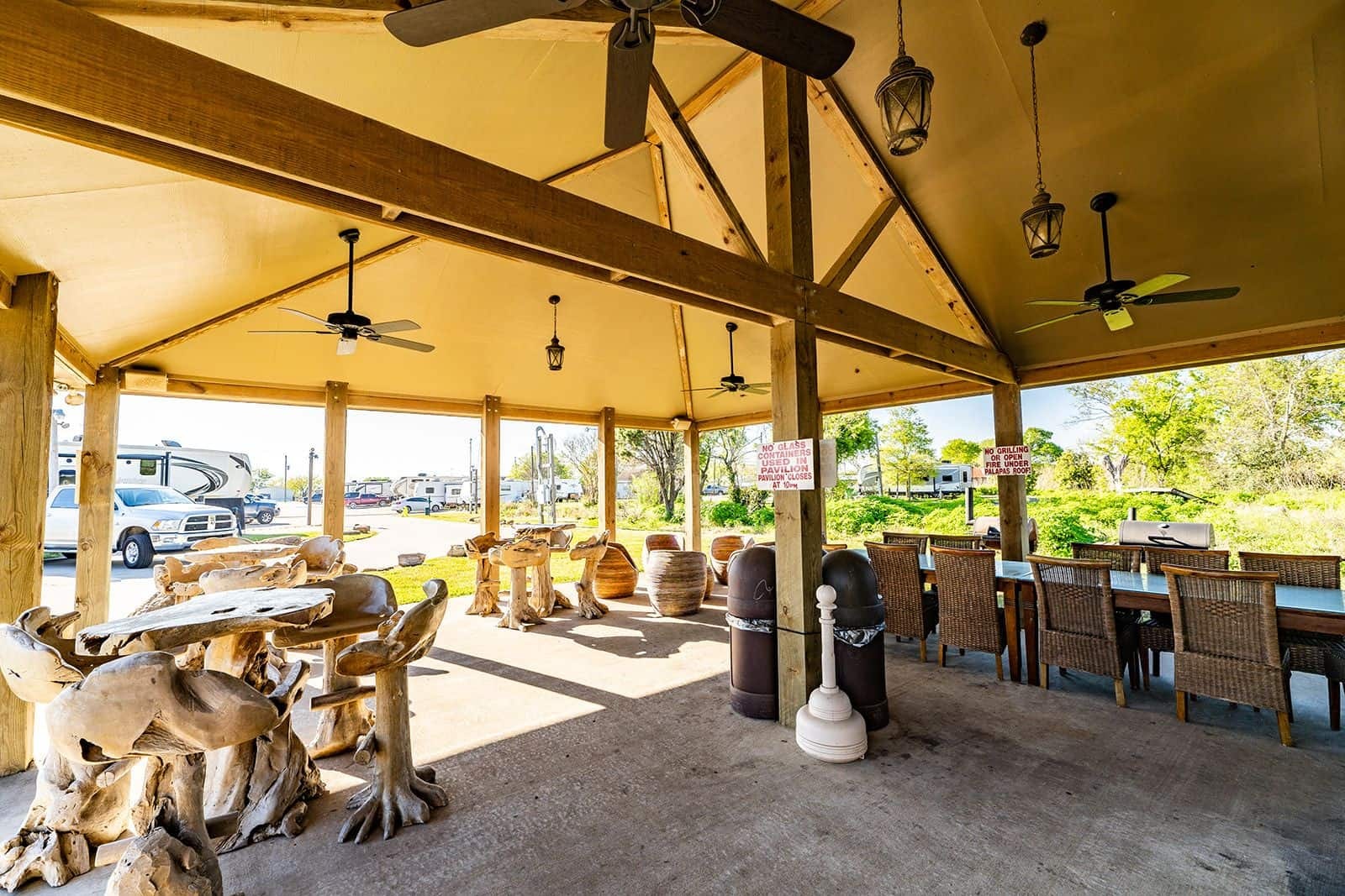 Covered BBQ pavilion with rustic wood furniture and ceiling fans — Gulf Coast 5 Star RV Resort